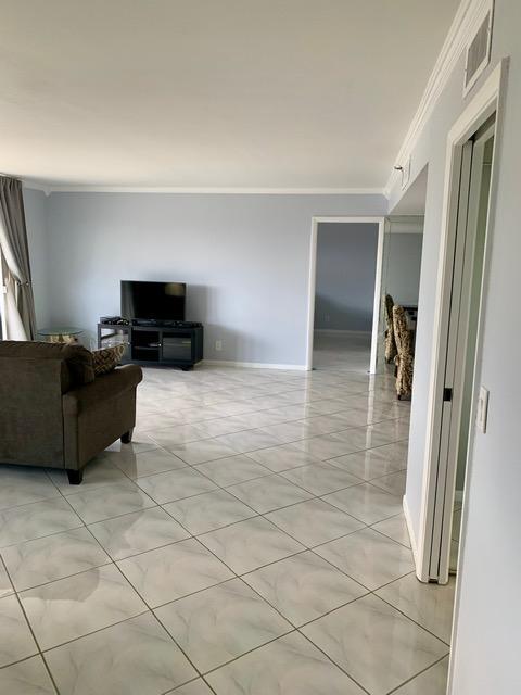 6400 Northwest 2nd Avenue, Unit 417 Boca Raton, FL 33487 - Photo 35 of 66 a living room with furniture and a flat screen tv