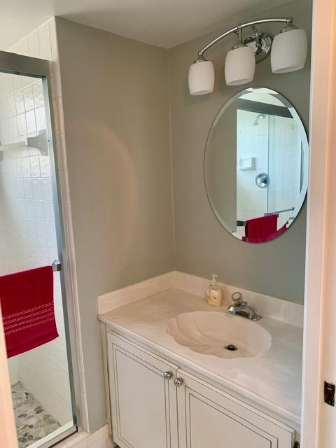 6400 Northwest 2nd Avenue, Unit 417 Boca Raton, FL 33487 - Photo 39 of 66 a bathroom with a sink and a mirror