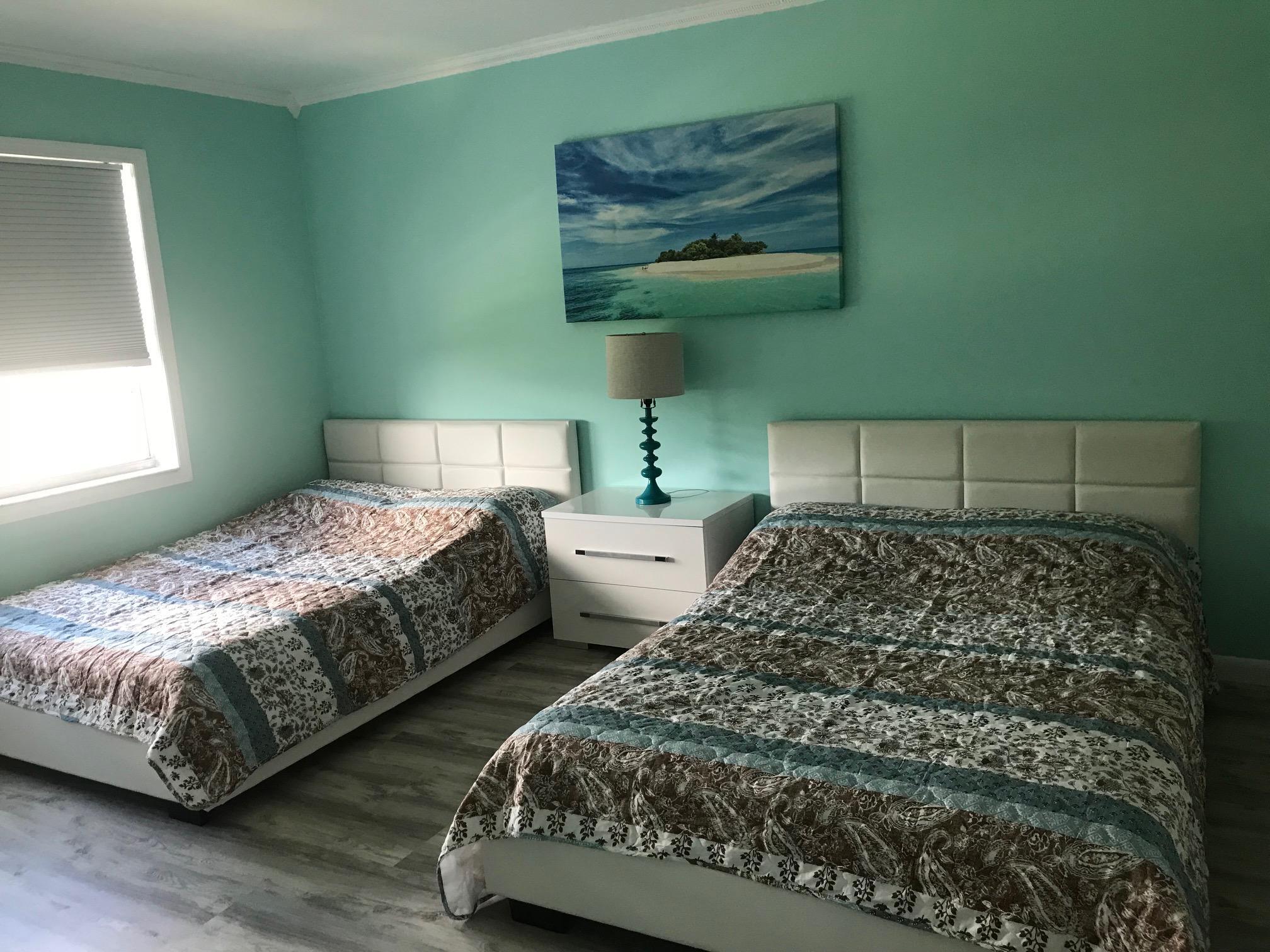 6400 Northwest 2nd Avenue, Unit 417 Boca Raton, FL 33487 - Photo 41 of 66 a bedroom with two beds and painting on the wall