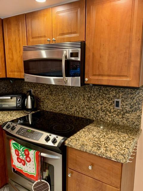 6400 Northwest 2nd Avenue, Unit 417 Boca Raton, FL 33487 - Photo 46 of 66 a close view of stove and microwave