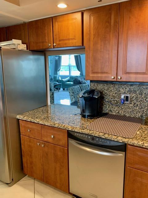 6400 Northwest 2nd Avenue, Unit 417 Boca Raton, FL 33487 - Photo 49 of 66 a kitchen with granite countertop cabinets and black stainless steel appliances