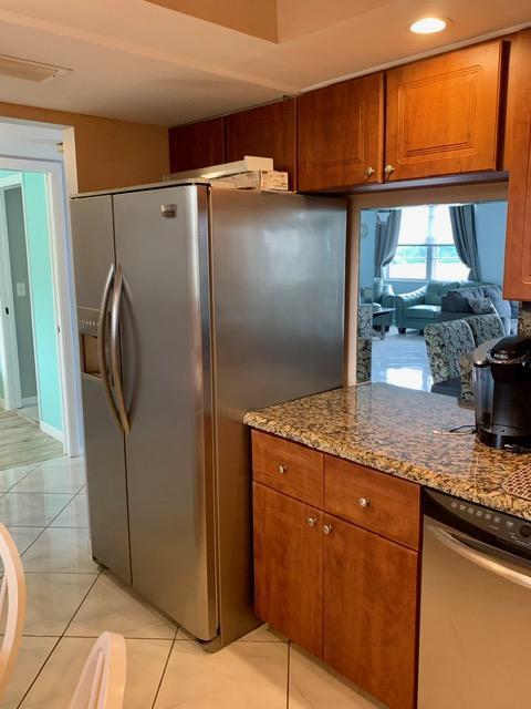 6400 Northwest 2nd Avenue, Unit 417 Boca Raton, FL 33487 - Photo 50 of 66 a kitchen with granite countertop a refrigerator and a sink