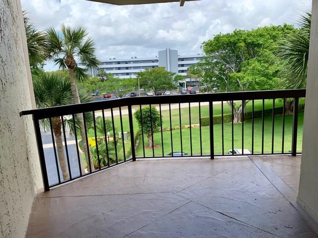 6400 Northwest 2nd Avenue, Unit 417 Boca Raton, FL 33487 - Photo 54 of 66 a view of balcony with floor to ceiling window and wooden fence