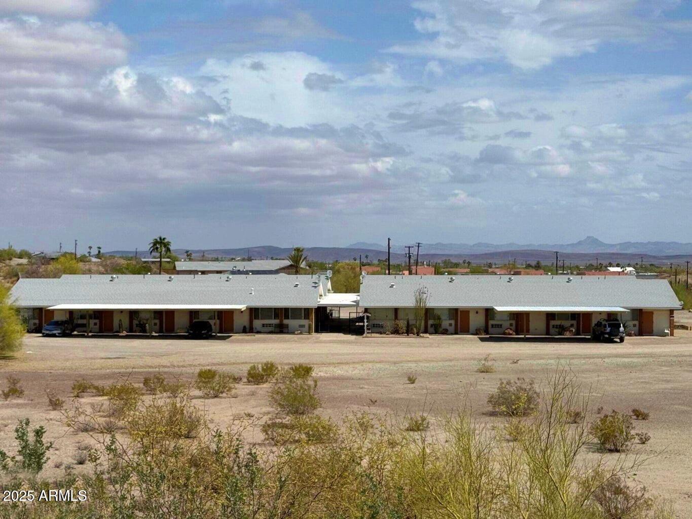 a view of a large pool with lawn chairs
