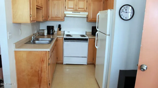 a kitchen with a refrigerator and a stove