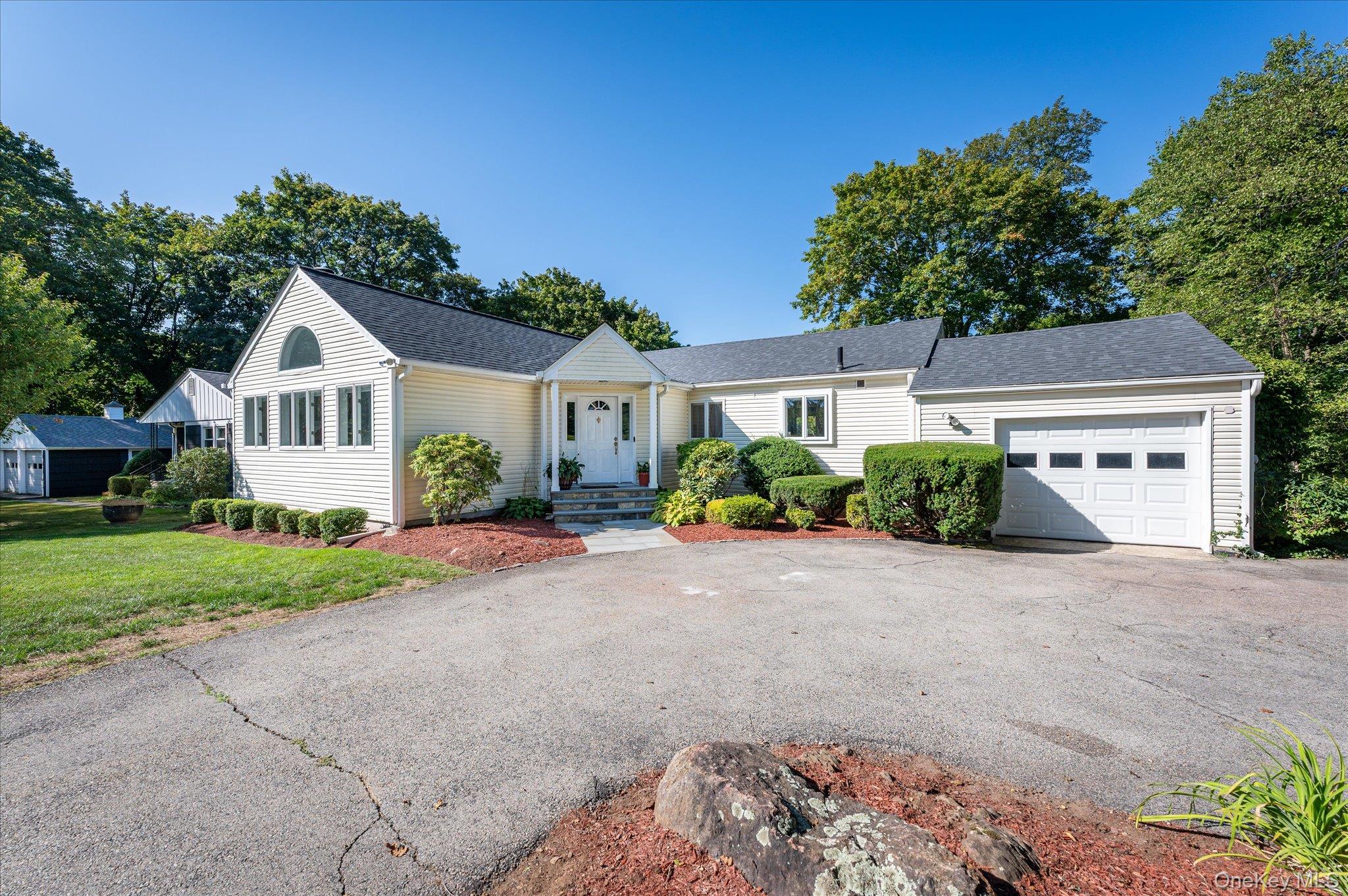 88 Oak Ridge Road Pleasantville, NY 10570 - Photo 1 of 1 a front view of a house with a yard and garage