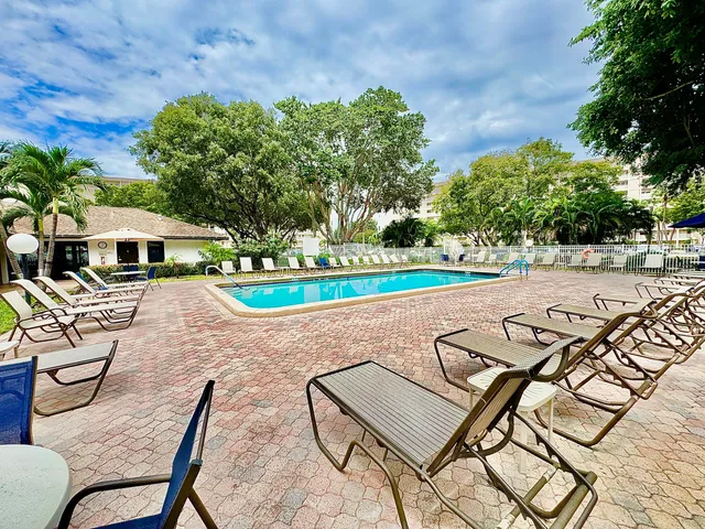 a view of a swimming pool with lounge chairs