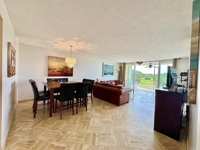 a living room with furniture a dining table and a piano table