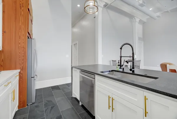 a kitchen with a sink and a refrigerator