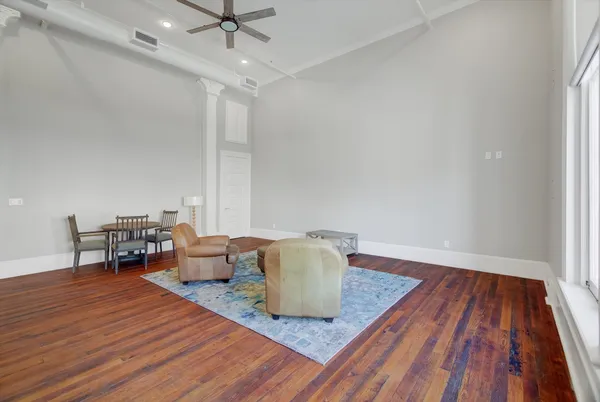 a living room with furniture and a wooden floor