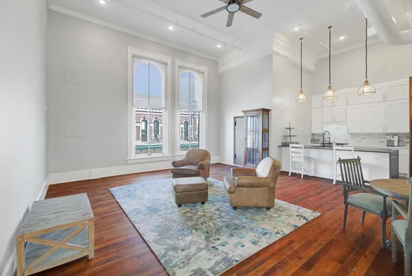 a living room with furniture and wooden floor