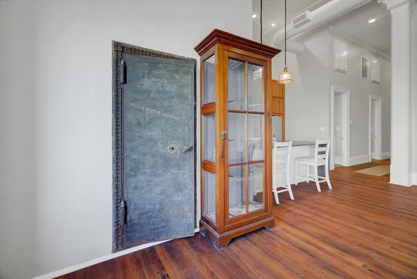 a view of a bathroom with wooden floor and a glass door