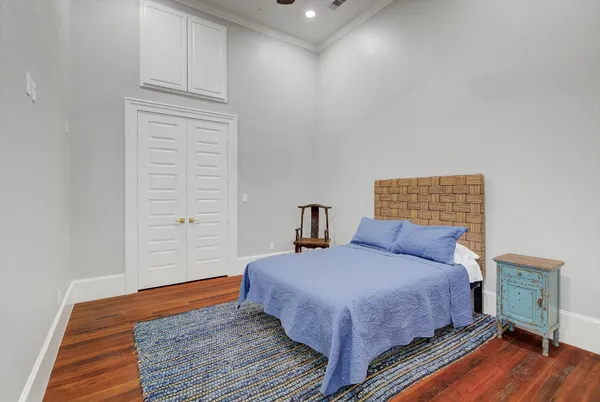 a bedroom with a bed and wooden floor