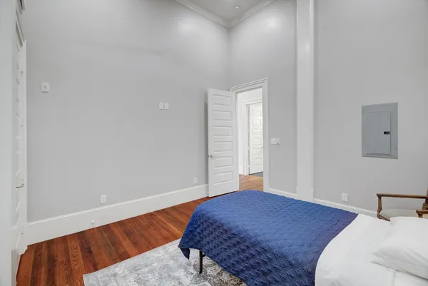 a bedroom with a bed and a night stand