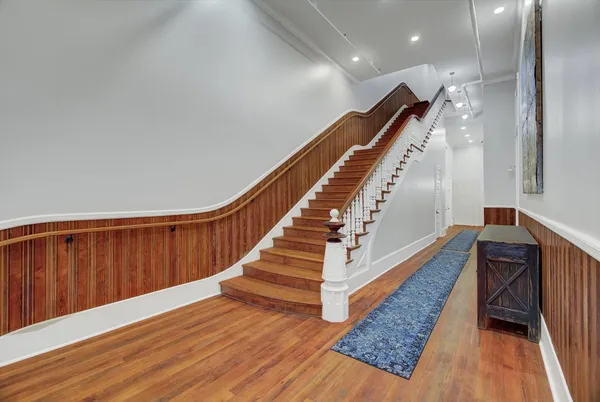 a bedroom with a bed and painting on the wall