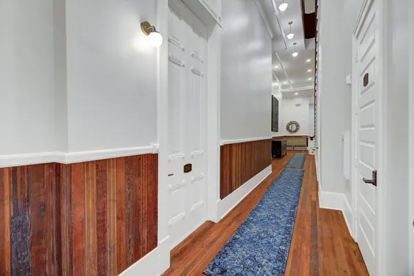 a view of gallery with wooden floor