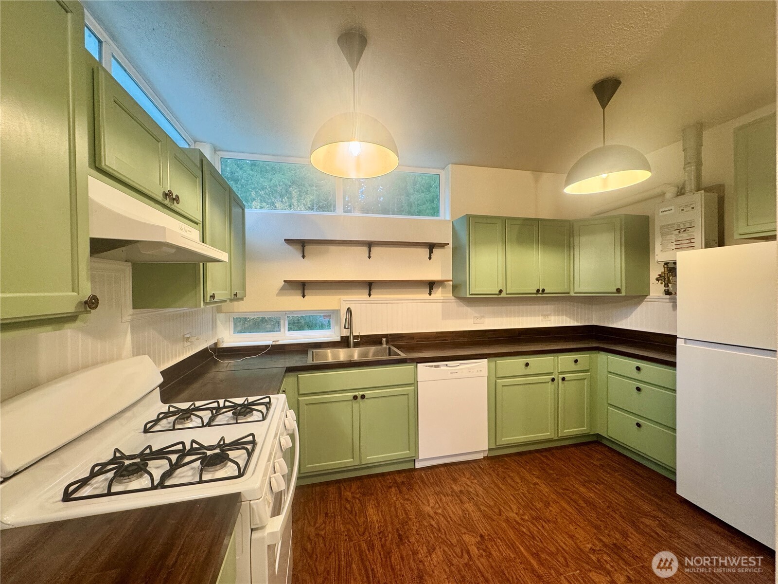 22305 Bald Hill Road Southeast Yelm, WA 98597 - Photo 15 of 39 a kitchen with a sink a stove cabinets and wooden floor