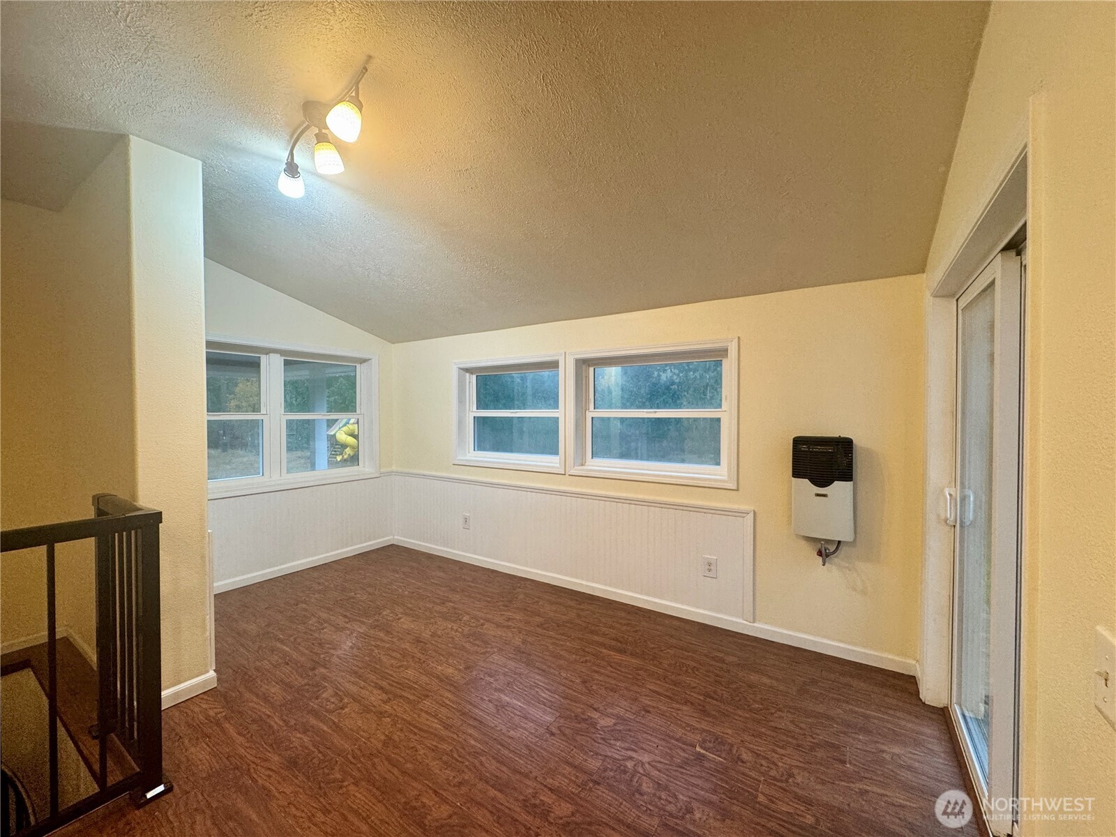 22305 Bald Hill Road Southeast Yelm, WA 98597 - Photo 17 of 39 a view of an empty room with wooden floor and a window