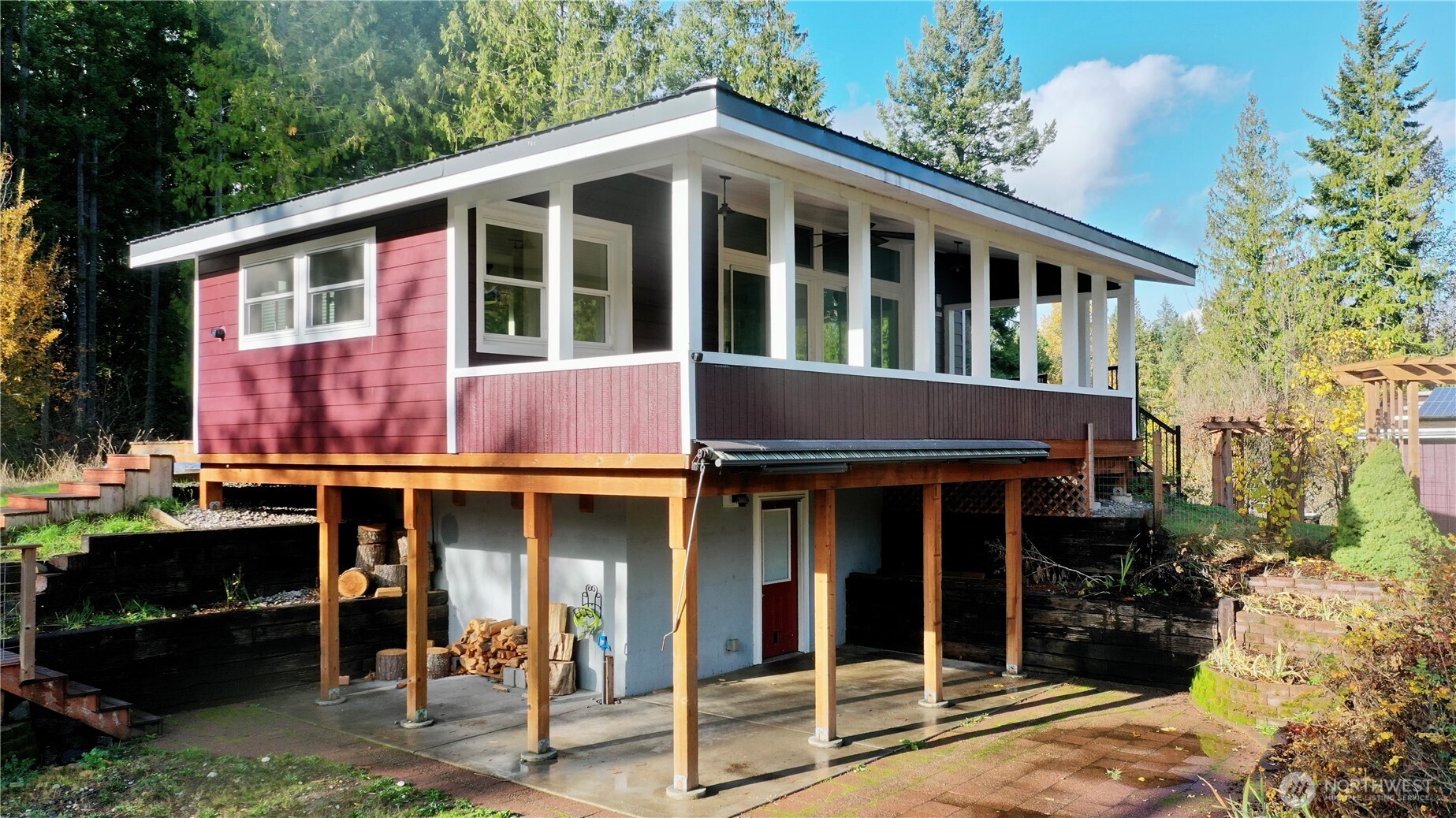 22305 Bald Hill Road Southeast Yelm, WA 98597 - Photo 2 of 39 a view of brick house with large windows and a table