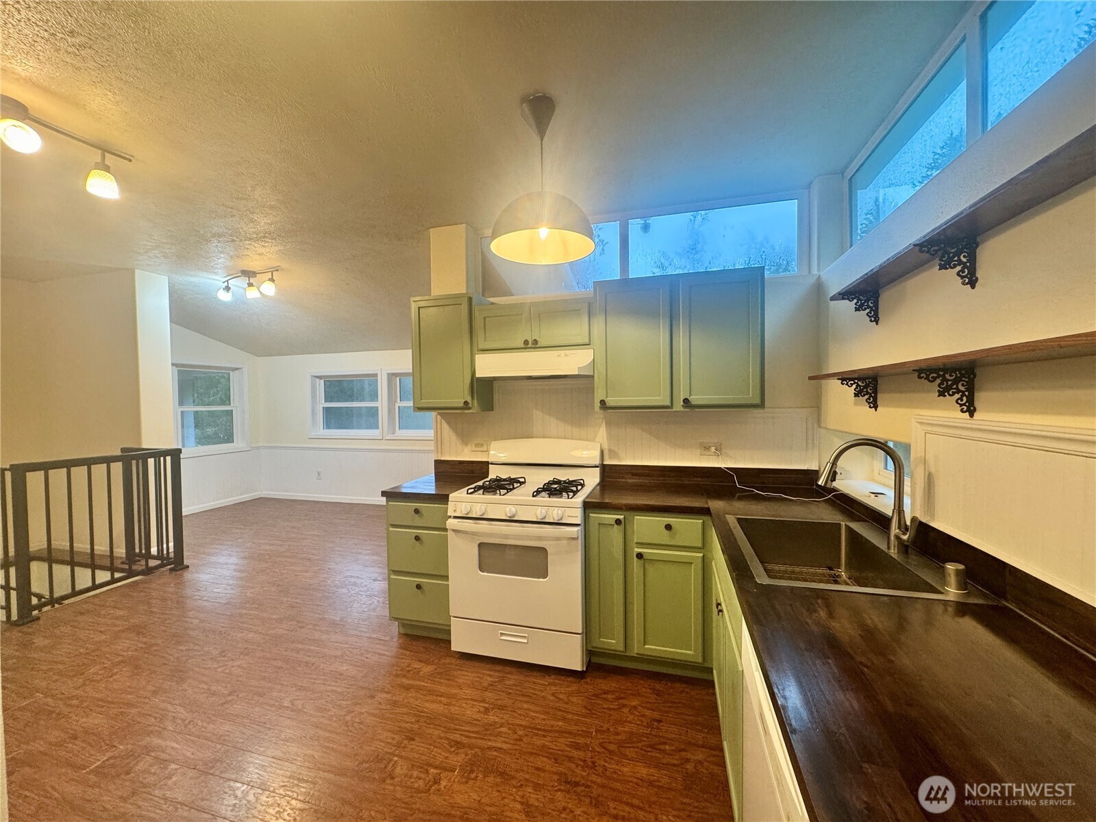 22305 Bald Hill Road Southeast Yelm, WA 98597 - Photo 8 of 39 a kitchen with a sink stove and cabinets