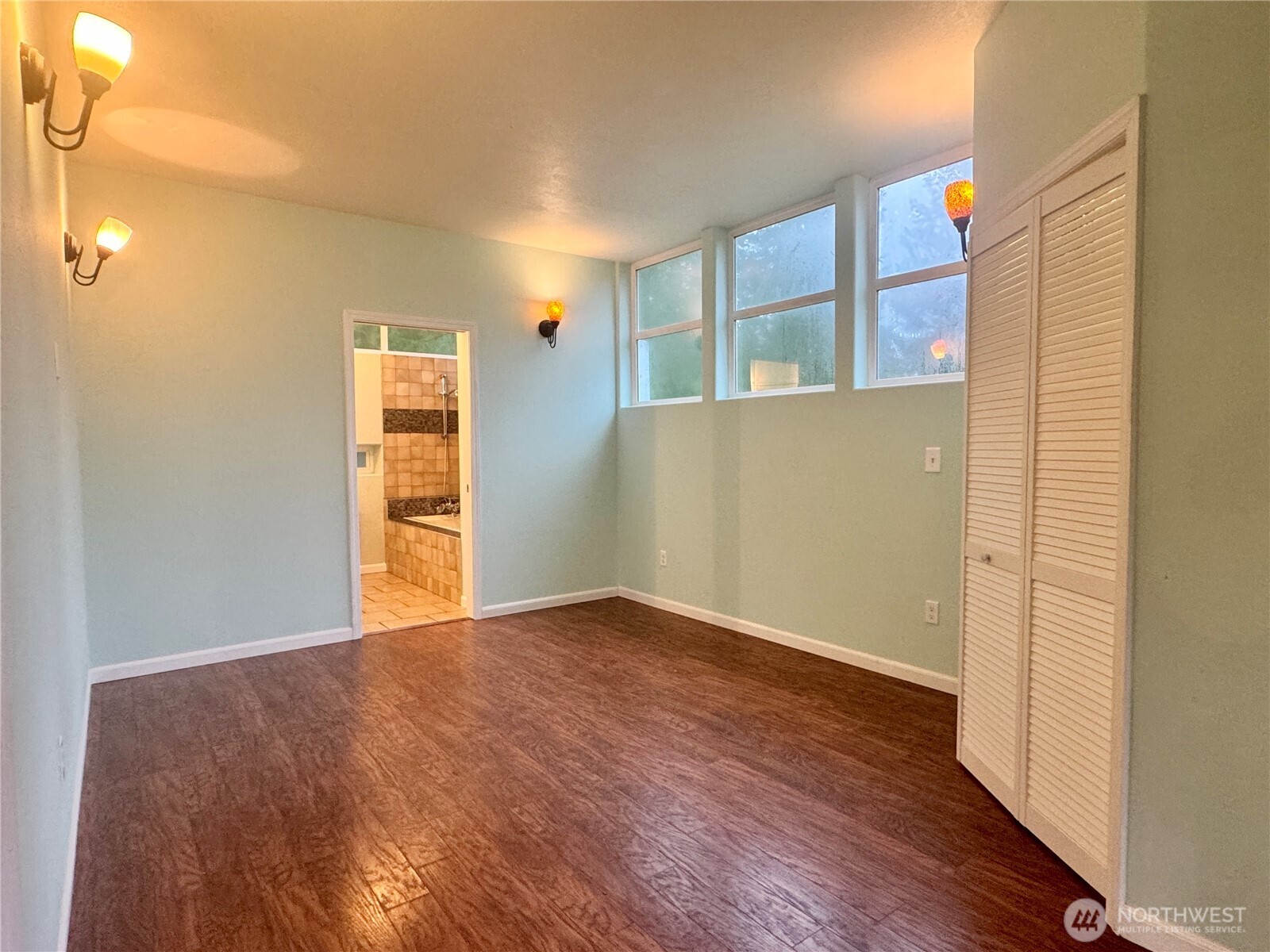22305 Bald Hill Road Southeast Yelm, WA 98597 - Photo 9 of 39 a view of an empty room with wooden floor and a window