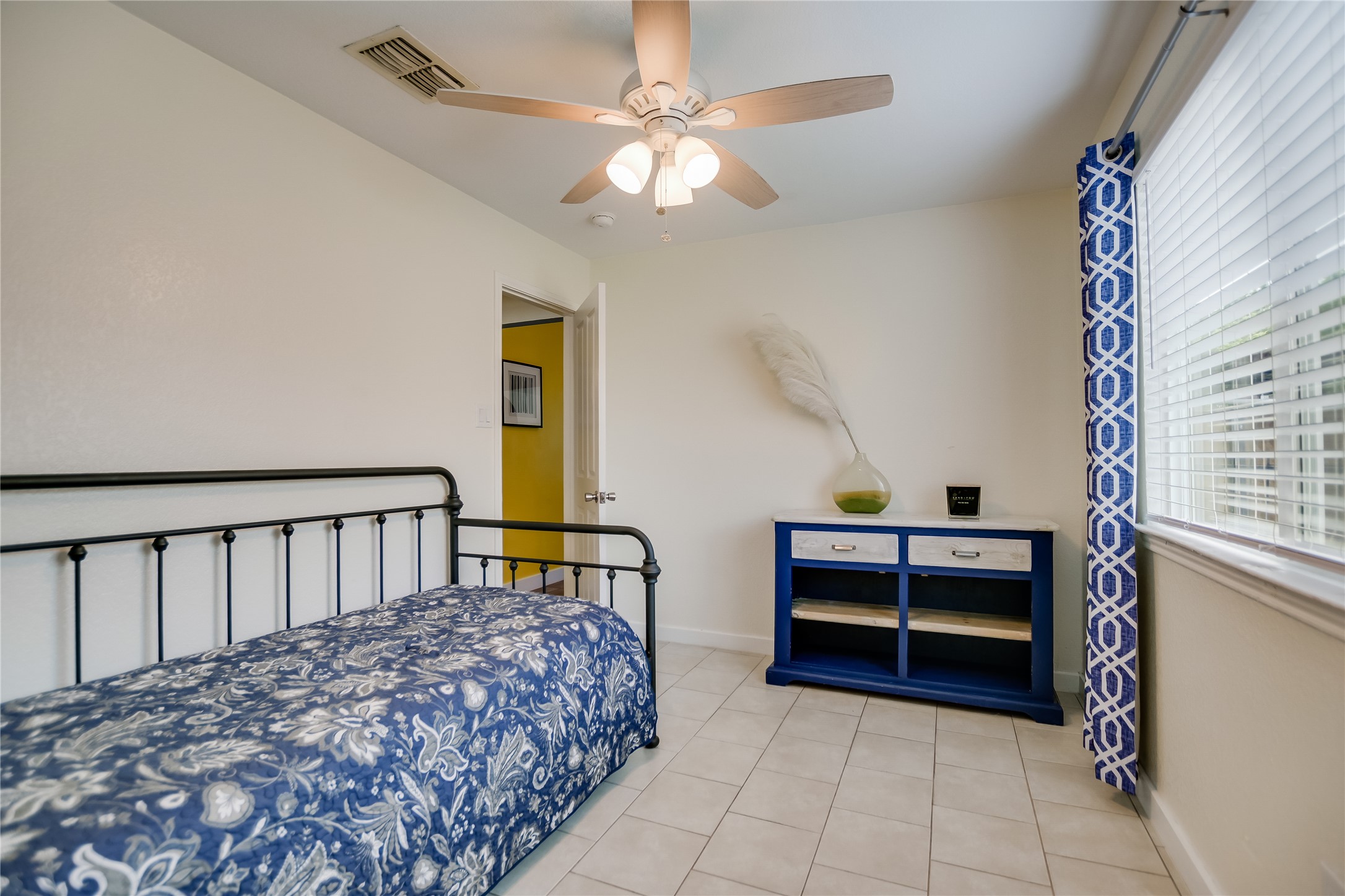 4702 Crest Oak Road Austin, TX 78744 - Photo 14 of 20 Interior space featuring a ceiling fan with light fixture, window with blinds, and light-toned tile flooring