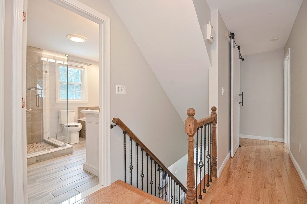 93 Cameron Road Norwood, MA 02062 - Photo 20 of 42 a view of a hallway with wooden floor and stairs