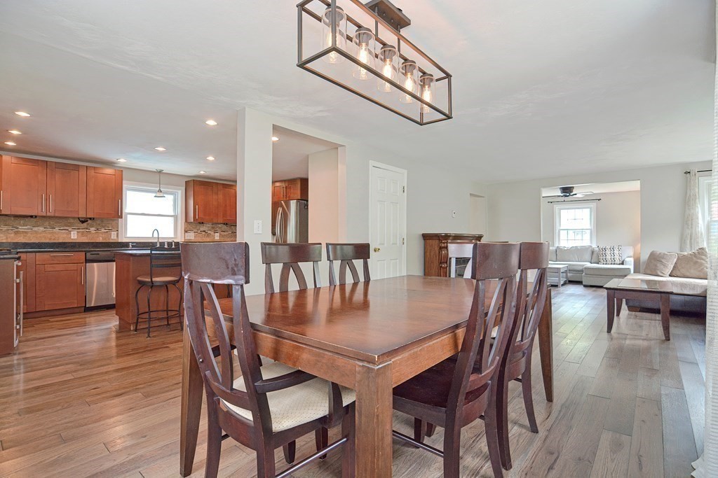 93 Cameron Road Norwood, MA 02062 - Photo 6 of 42 a view of a dining room and livingroom with furniture wooden floor a chandelier