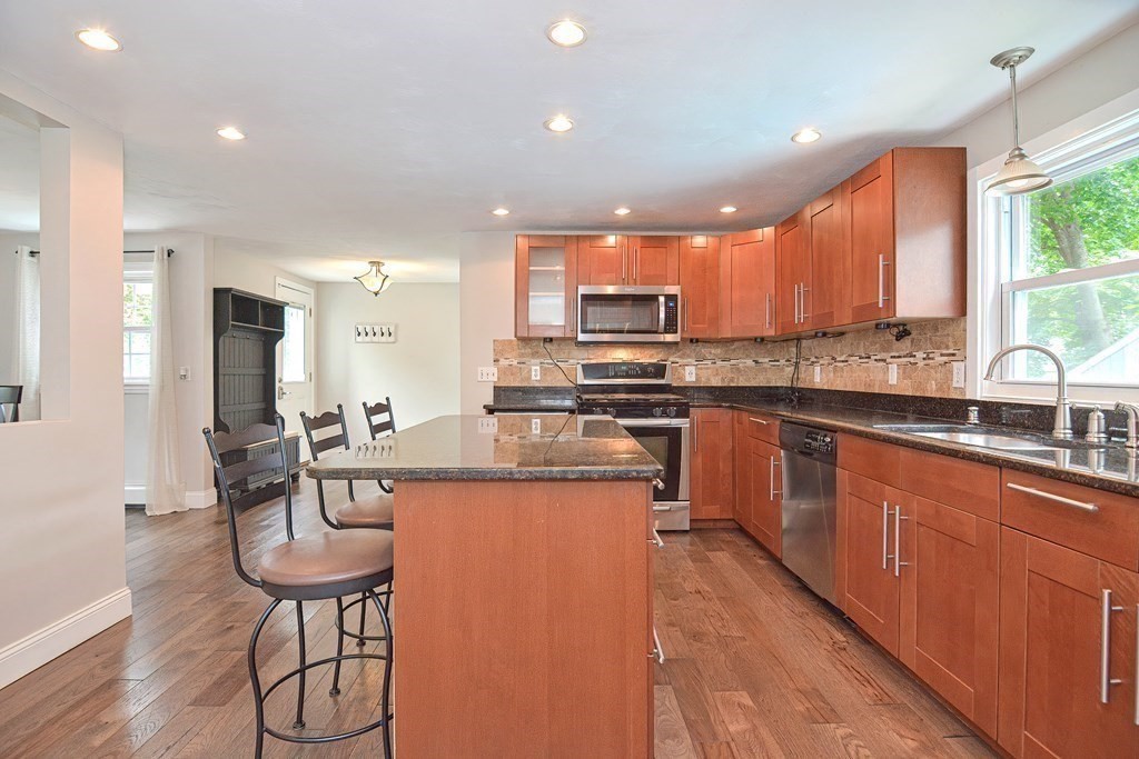 93 Cameron Road Norwood, MA 02062 - Photo 10 of 42 a kitchen with stainless steel appliances kitchen island granite countertop a sink and cabinets
