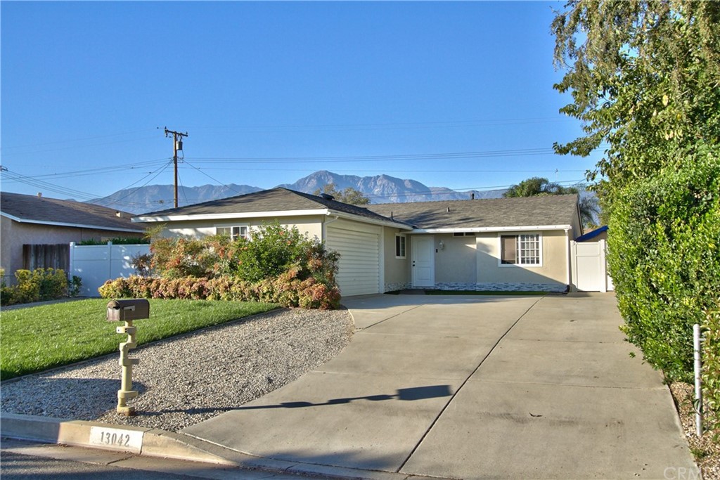 13042 Chestnut Avenue Rancho Cucamonga, CA 91739 - Photo 1 of 1 a front view of a house with a yard and potted plants