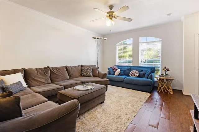 a living room with furniture and a chandelier