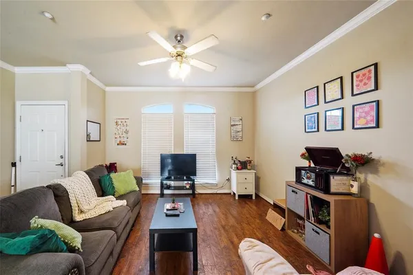 a living room with furniture and wooden floor