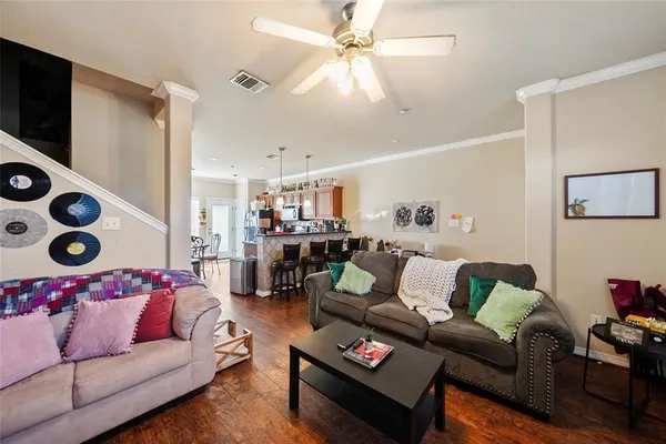 a living room with furniture and wooden floor
