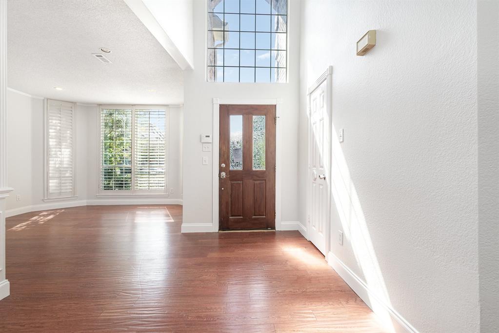 906 Beau Drive Coppell, TX 75019 - Photo 12 of 35 wooden floor in a hall with an entryway and a window