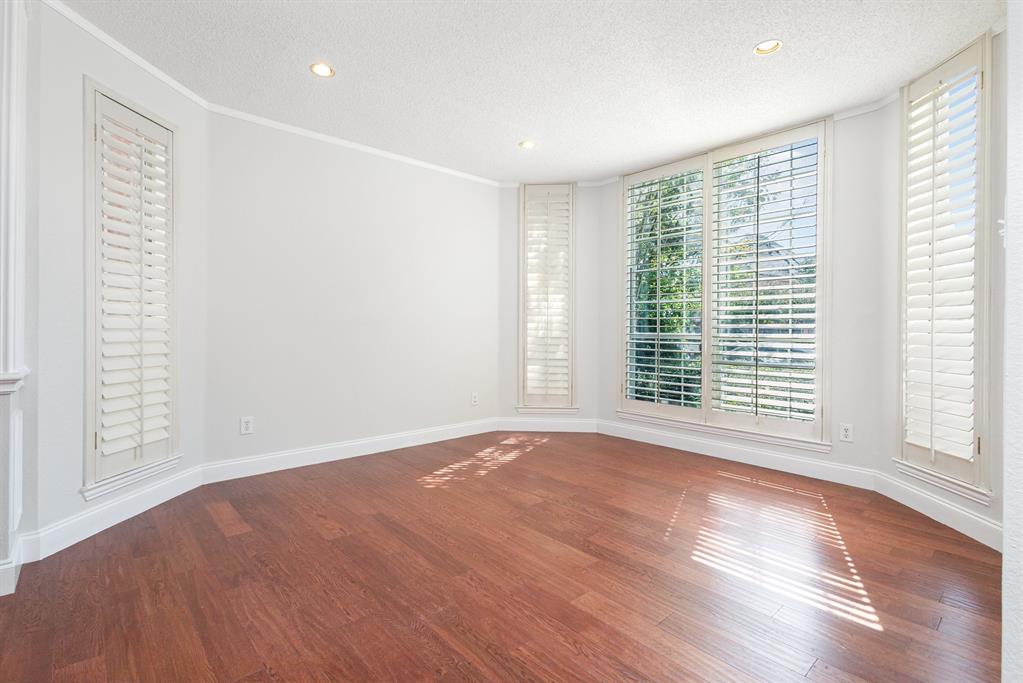 906 Beau Drive Coppell, TX 75019 - Photo 13 of 35 a view of an empty room with wooden floor and a window