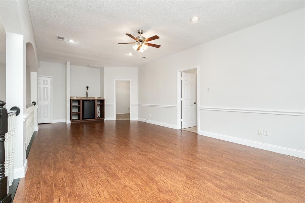 906 Beau Drive Coppell, TX 75019 - Photo 17 of 35 a view of empty room with wooden floor and ceiling fan