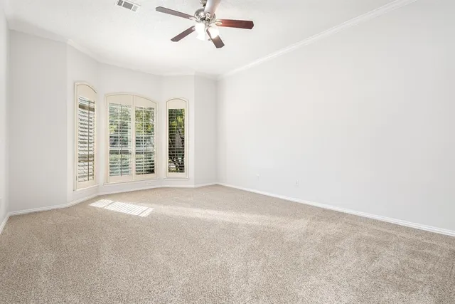 a view of an empty room with a ceiling fan