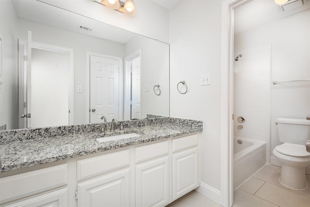 906 Beau Drive Coppell, TX 75019 - Photo 30 of 35 a bathroom with a granite countertop sink and a mirror