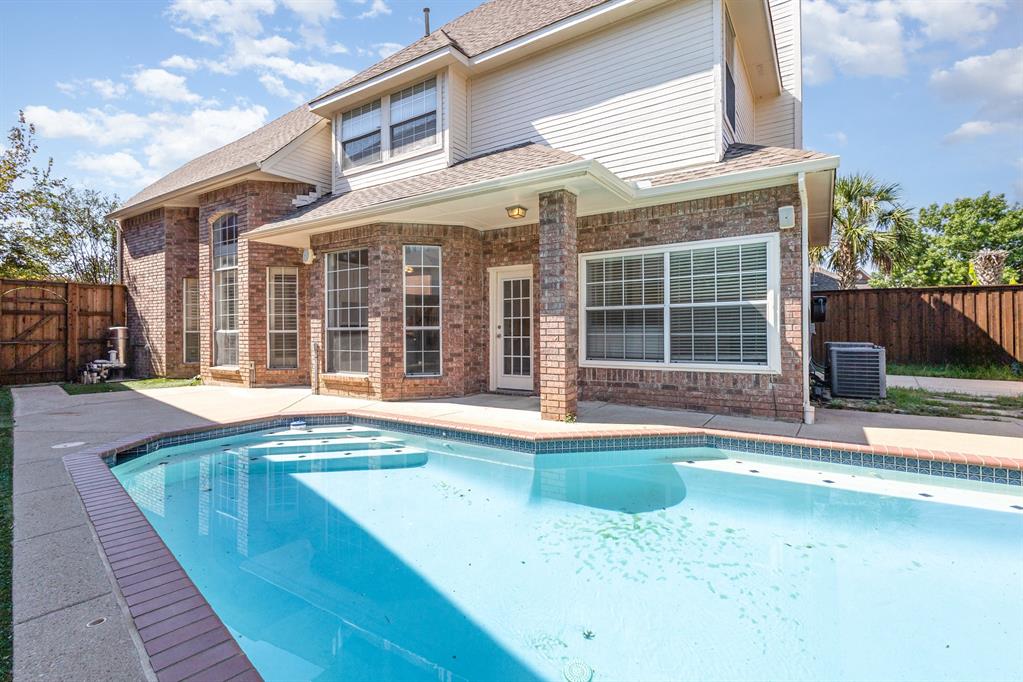 906 Beau Drive Coppell, TX 75019 - Photo 33 of 35 a view of a house with a swimming pool and a porch