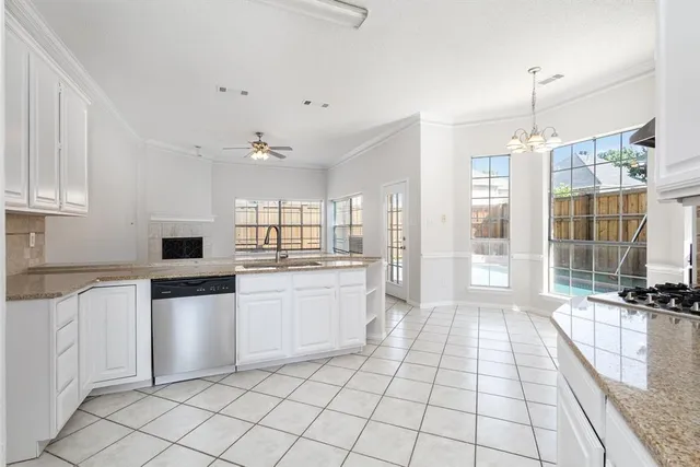 a kitchen with a stove a sink and a refrigerator