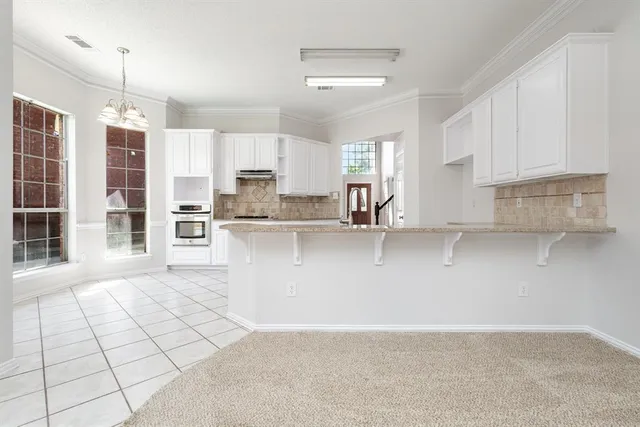 a view of a kitchen with furniture and a ceiling fan