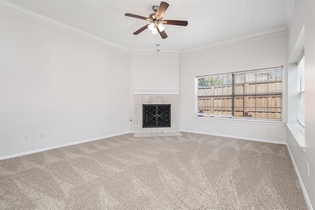 906 Beau Drive Coppell, TX 75019 - Photo 10 of 35 an empty room with windows and fireplace