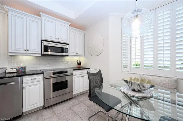 a kitchen with stainless steel appliances kitchen island granite countertop a sink and a stove