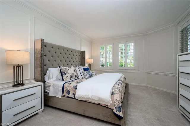 a bedroom with a bed and a night stand