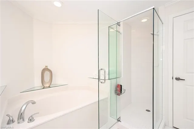 a bathroom with a sink vanity and shower