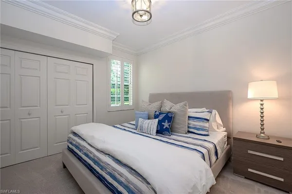 a bedroom with a bed and a lamp