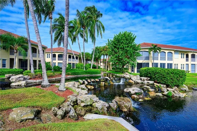 a front view of a house with garden and sitting area