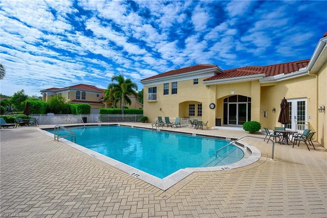 a view of a house with pool porch and sitting area