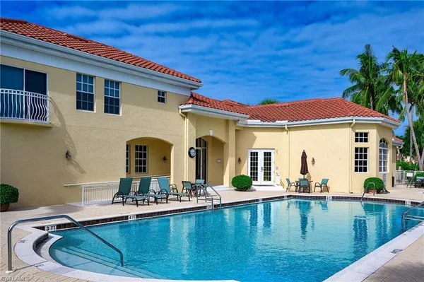 a view of swimming pool with outdoor seating