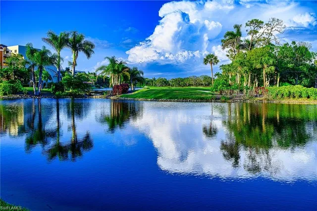 a view of a lake with a building and a big yard